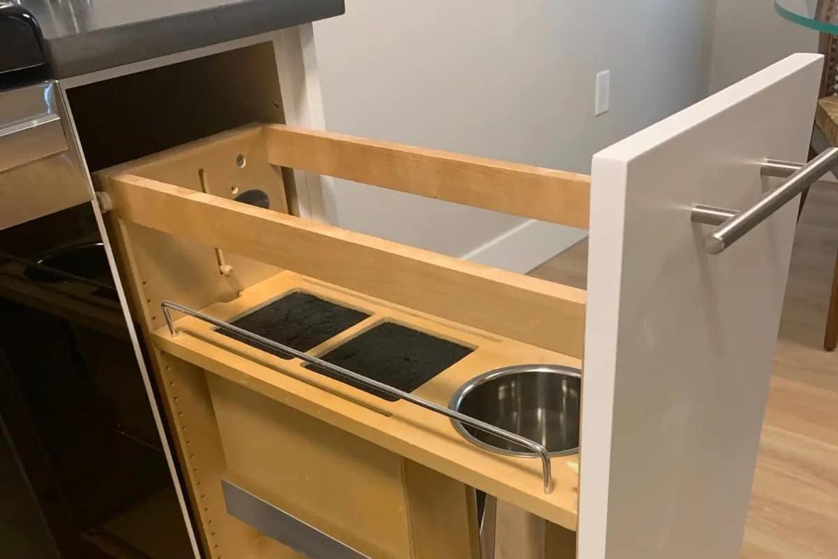 Custom kitchen pull-out cabinet with built-in cut outs.