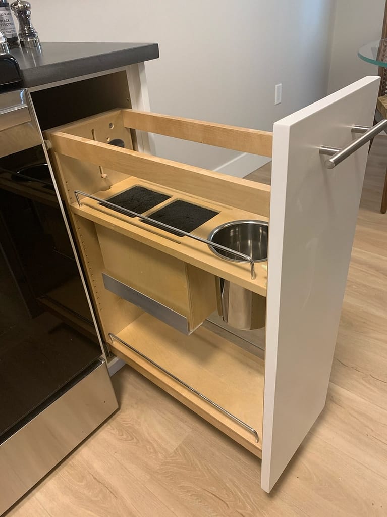 Custom kitchen pull-out cabinet with built-in cut outs.